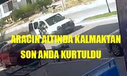 Aracın altında kalmaktan son anda kurtuldu